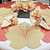 7 Point Leaf - Gold/Copper & Bronze Carole Shiber Designs, decorative table centerpiece with folded fabric roses and table mats resembling leaves.