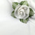 Add a White with White Trim Napkin Carole Shiber Designs, a white napkin with a decorative white rose and green leaves details for elegant table setting.