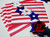 Add a Blue and White Star Napkin Rings Carole Shiber Designs, patriotic red, white, and blue themed napkin rings with star shapes and a red rose decoration.