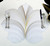7 Point Leaf - White/Gold & Silver Carole Shiber Designs, elegant table setting with silverware placed on a leaf-shaped placemat with white, gold, and silver accents, perfect for sophisticated dining arrangements.