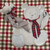 Teddy Bear Place-Setting with Plaid Ribbons, decorative teddy bear plush with plaid ribbon, a plush toy bear, and a spoon on a teddy bear-shaped placemat on a plaid tablecloth.