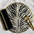 Zebra on the Round Carole Shiber Designs, decorative zebra print round placemat with black napkin and gold cutlery.