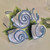 Hydrangea Table Set for 4, decorative napkin holder designed as white and blue fabric roses with green fabric leaves.