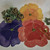 Pansy Trio/Centerpiece, colorful pansy-shaped decorative plates in yellow, purple, and red.