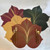 Autumn 4 Leaf Placemats, decorative fall-themed paper placemats in red, yellow, and green shades arranged in a leaf pattern.