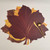 Jeweltone Maple Leaf Placemats, SALE! - Close-up of colorful maple leaf-shaped placemats in jewel tones with a gold spoon and fork on top.