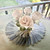 Jeweltone Mums, decorative table centerpiece featuring white fabric roses and green leaves arranged on a flower-shaped placemat.