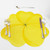 Buttercup Placemat - Yellow, a bright yellow floral-shaped placemat with a detailed black dotted center, used as tableware setting with silverware on a white background.