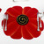 Red Poppy with Black/Gold Swirl - Limited Edition! Carole Shiber Designs, decorative plate designed like a vibrant red poppy flower with black and gold swirl center, accompanied by silver cutlery on a white background.