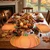 Painterly Pumpkin Placemat by Carole Shiber, a fall-themed table setting with pumpkin-shaped placemats, autumn leaves, candles, pumpkins, and holiday decor.