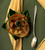 Custom Napkins Builder Carole Shiber Designs, image of fabric napkins arranged in a spiral flower shape with a silver spoon on a dark and beige surface.
