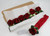 Classic Red Rose Napkin Bouquet Carole Shiber Designs, a set of artificial red roses with green leaves arranged as a napkin bouquet with a red ribbon, in a cardboard box. Classic Red Rose Napkin Bouquet Carole Shiber Designs, a set of artificial red roses with green leaves arranged as a napkin bouquet with a red ribbon, in a cardboard box.