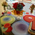 Cosmic Color Dots, Set of 4 Carole Shiber Designs tableware with colorful swirling dot patterns on plates, napkins, and decorative glass vases.