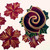 Hand-Painted Hollyberry Rings, Red Carole Shiber Designs, featuring a rolled holly berry design with gold accents and green leaves, surrounded by cut-out holly berry shapes with gold detailing.