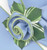 Light Blue with HoneyDew Trim Napkin, decorative napkin with a rolled blue fabric and a green leaf with white streaks in a floral design by Carole Shiber Designs. Light Blue with HoneyDew Trim Napkin, decorative napkin with a rolled blue fabric and a green leaf with white streaks in a floral design by Carole Shiber Designs.