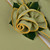 Sage with Gold Trim Napkin, a decorative napkin folded into a rose shape with gold-stitched edges, designed by Carole Shiber Designs.