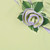 HoneyDew with Lilac Trim Napkin Carole Shiber Designs, decorative fabric napkin with a lilac trim styled with green leaves and a lilac spiral embellishment.