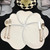 Buttercream and Grey Carole Shiber Designs table setting with floral-shaped placemats and elegant silverware
