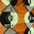Moonscape 8's Tablescape Carole Shiber Designs, a dinner table setting with black and white circular placemats, gray napkins with black borders, stainless steel flatware, and wine glasses, on a wooden table. Moonscape 8's Tablescape Carole Shiber Designs, a dinner table setting with black and white circular placemats, gray napkins with black borders, stainless steel flatware, and wine glasses, on a wooden table.