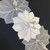 Sterling Silver Placemat Carole Shiber Designs, decorative silver placemats with floral design and a silver candle holder with a white candle.