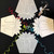 Party Gift Boxes, Neutral Set 4 by Carole Shiber Designs, clear hexagonal gift boxes with floral designs, colorful curling ribbons on a black background.