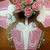 Vintage Party Gift Box - Pink/White Carole Shiber Designs, decorative pink and white gift boxes with floral patterns on a table with a floral centerpiece, glassware, and cutlery.