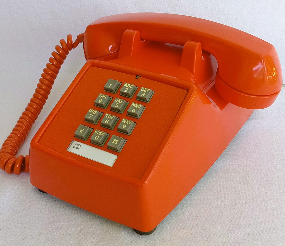 Orange 2500 touch tone telephone made by ITT formerly Stromberg