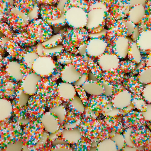 Close-up of Hugos White Choc Sparkles with multi-colour jewels from an 8kg box at The Professors Online Lolly Shop.