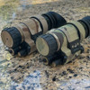 Angled front view of PVS-14 night vision monoculars protected by the Multicam 500D Cordura wrap by Reese Wraps