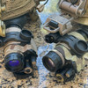 Angled front view of 2 PVS-14 night vision monoculars protected by the Multicam 500D Cordura wrap by Reese Wraps