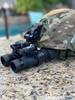 Front view of a camouflage Team Wendy helmet equipped with a AB Night Vision RNVG Fixed Bridge night vision goggle showcasing a custom turn key setup
