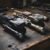 Black and FDE variations of the USNV Advanced Mission Ready Kit with Emissary Alternator resting on a tactical workbench