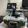 AN PVS-14 night vision monocular undergoing rigorous quality control testing on a Hoffman Engineering rig prior to kit assembly