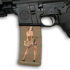 Side profile of an AR-15 lower receiver showing a tan magazine customized with the Hot Shots 2013 Rosie Mag Slaps pin-up decal