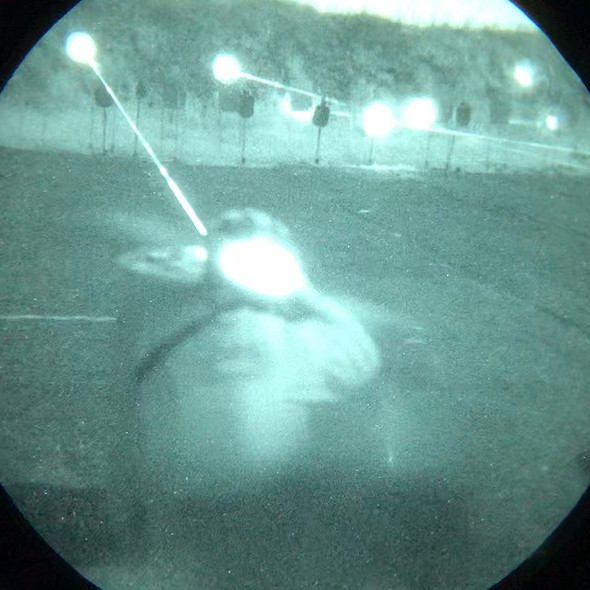 Through the tube night vision view demonstrating the powerful beam of the DesignateIR infrared aiming laser on a nighttime range