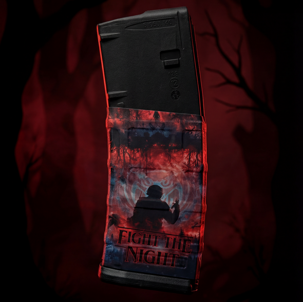 Stylized atmospheric display of the Strange Things Mag Wraps AR-15 magazine vinyl wrap in a dark red setting