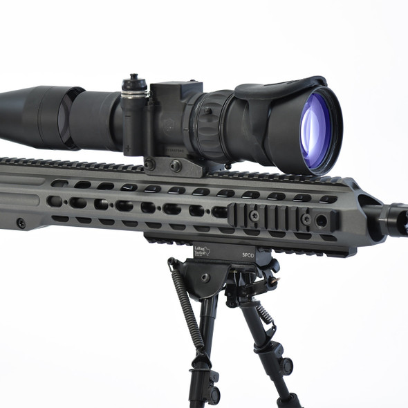Side profile of the Knight Vision AN/PVS-30 night vision sight mounted on a precision rifle rail directly in front of a day scope