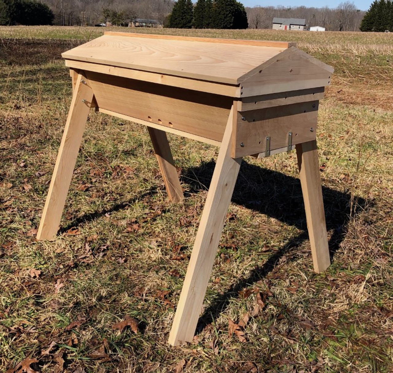 The Gold Star top bar hive - front view.  Made from sustainably harvested cypress, it comes with a light-weight, gabled roof, and sturdy removable legs.