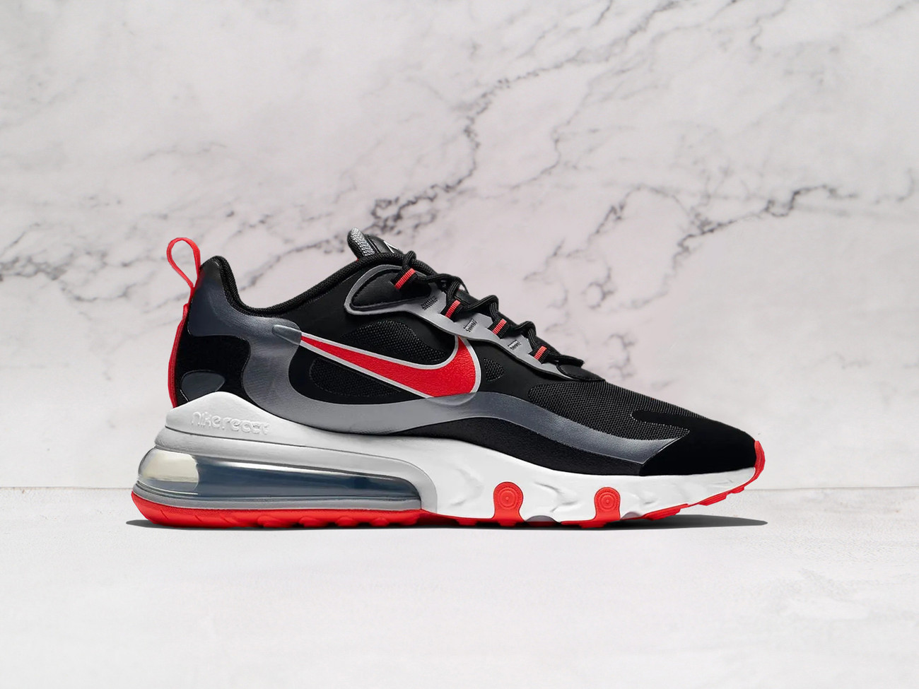 Nike Air Max 270 React Black Bright Crimson medial angle showcasing breathable mesh construction, no-sew overlays, and a durable rubber outsole for all-day comfort and traction