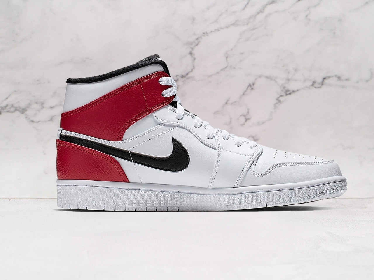 Close-up of the Air Jordan 1 Mid White Chicago showing the premium white leather upper and Nike Air cushioning
