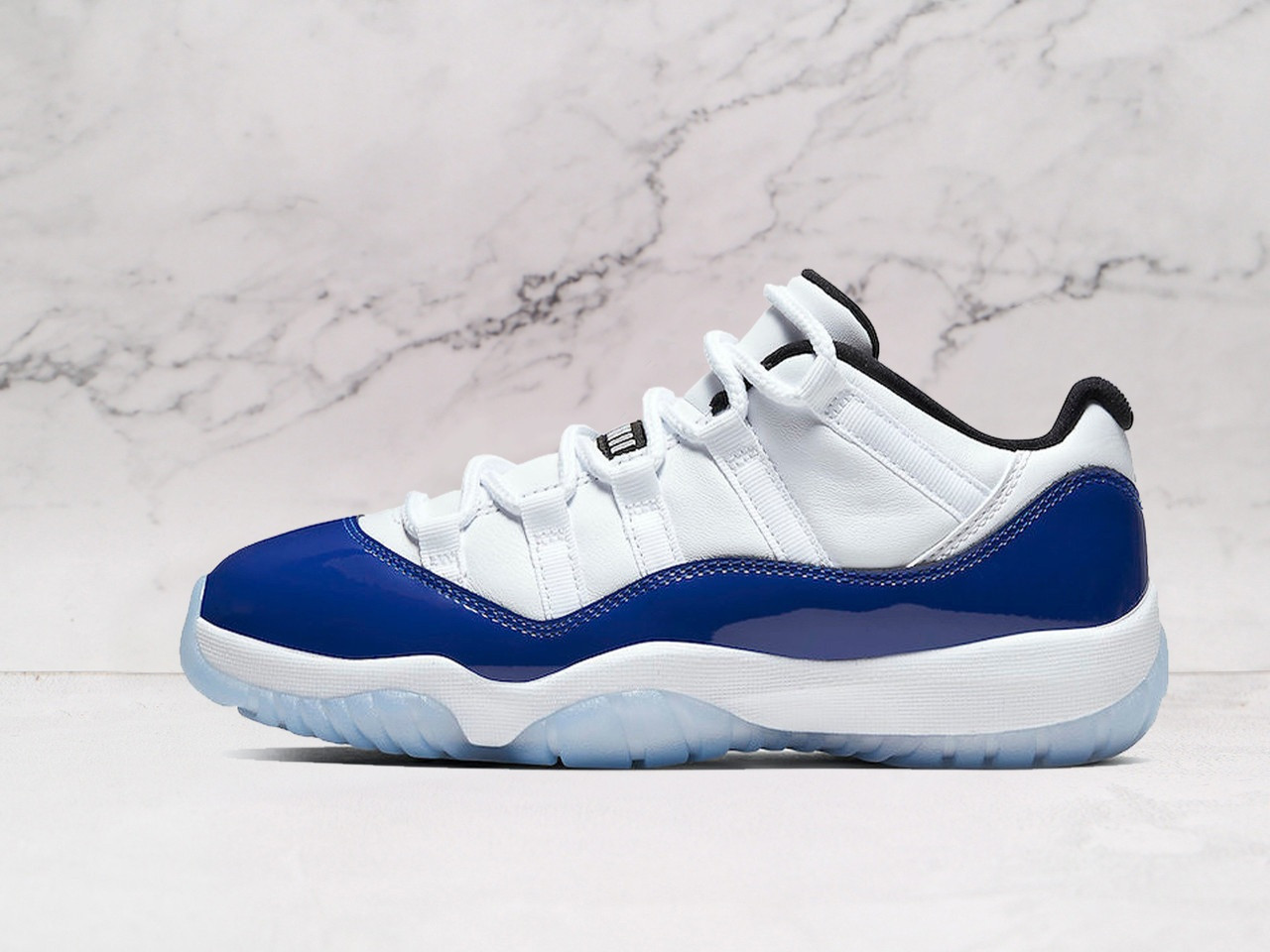 Side view of Air Jordan 11 Retro White Concord with Black patent leather and White mesh.