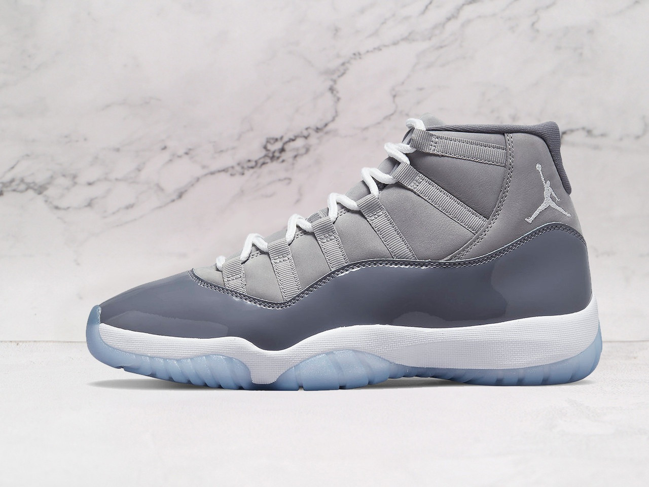 Air Jordan 11 Retro Cool Grey side view, grey nubuck upper with patent leather mudguard.