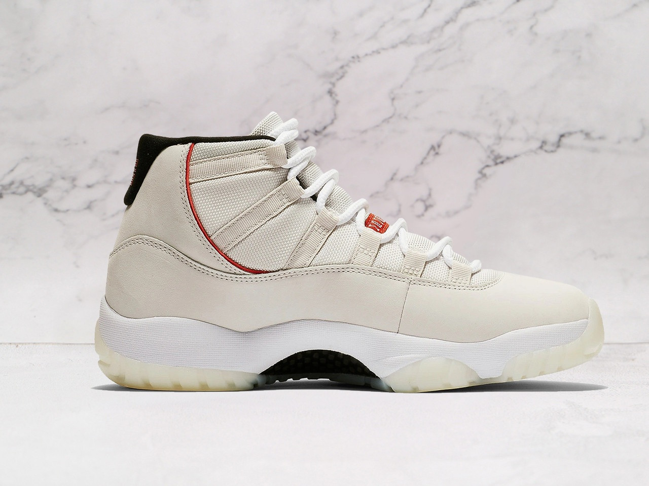Medial view of Air Jordan 11 Retro 'Platinum Tint' with nubuck upper and patent leather trim