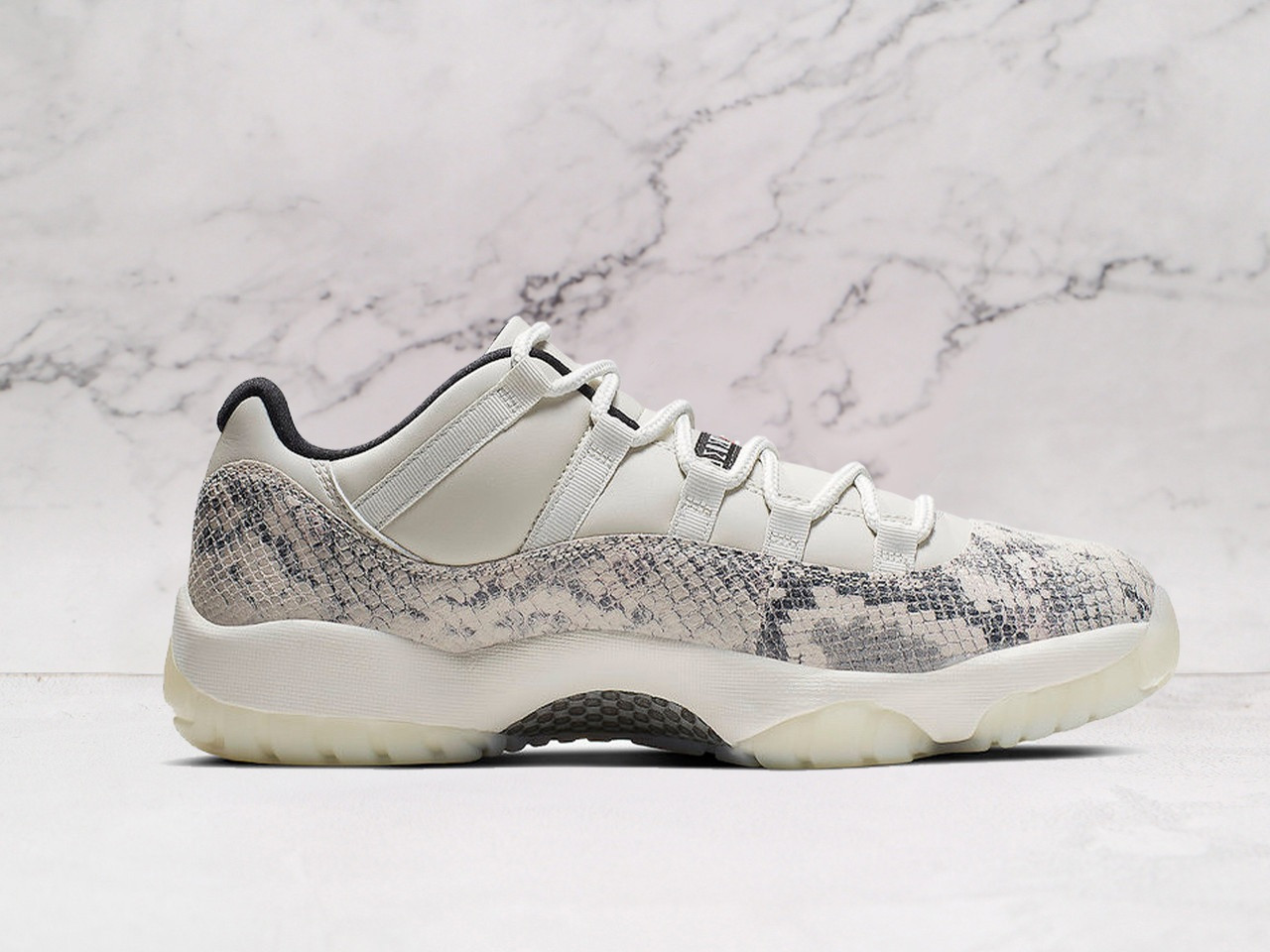 Medial view of Air Jordan 11 Retro Low 'Light Bone Snakeskin' with snakeskin vinyl and University Red Jumpman