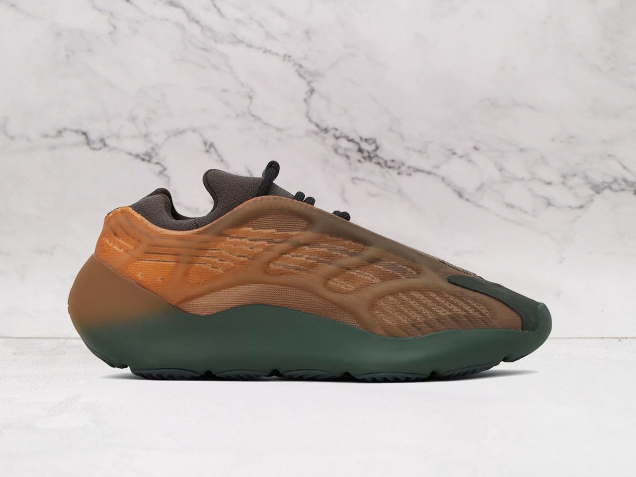 Yeezy 700 V3 Orange sneaker side profile featuring a glow-in-the-dark RPU cage and Primeknit upper