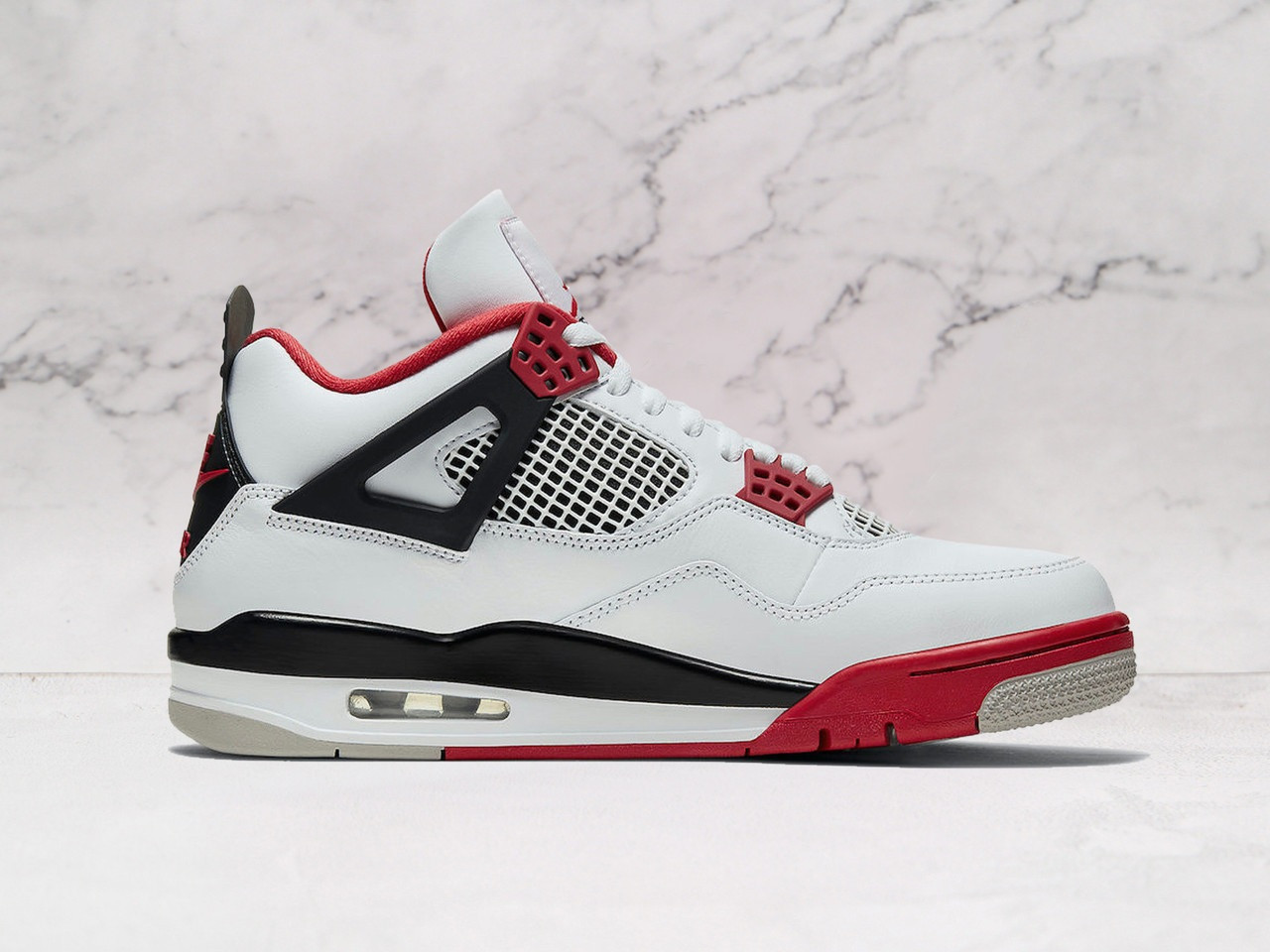 Close-up of Air Jordan 4 Retro Fire Red with visible Air cushioning and iconic Fire Red accents
