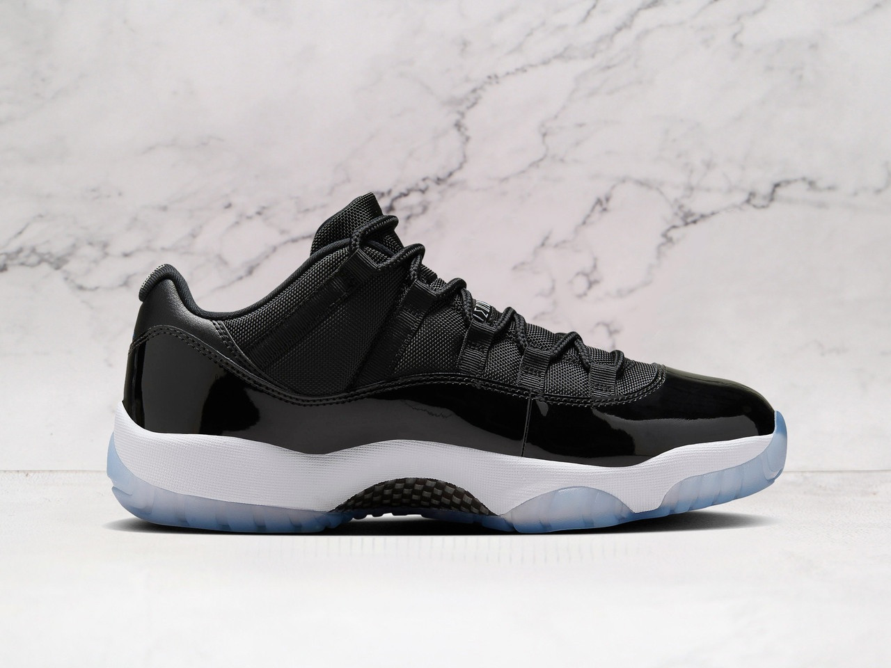 Medial view of Jordan 11 Retro Low Space Jam with Varsity Royal Jumpman and icy outsole
