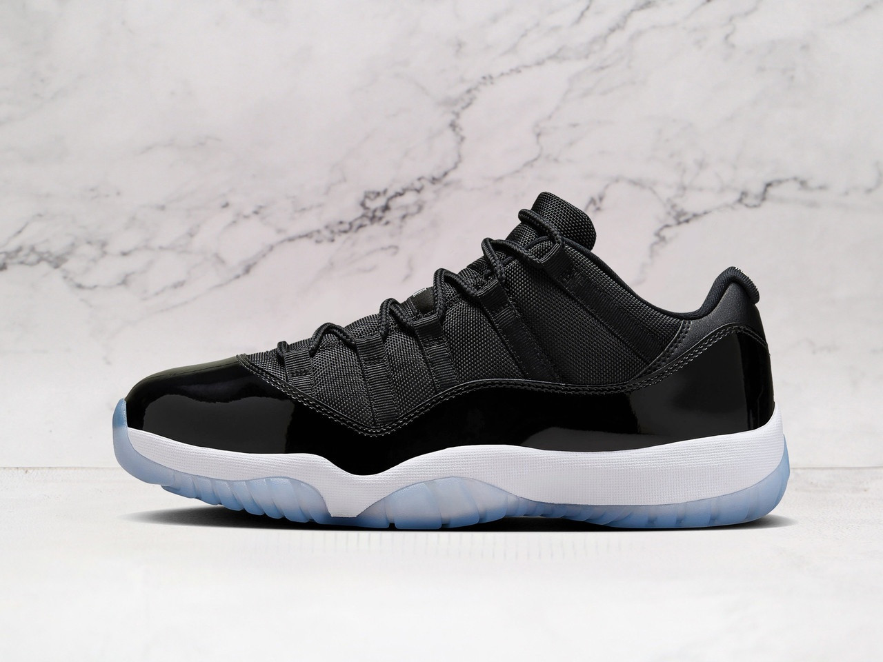 Side view of Jordan 11 Low Space Jam with Black patent leather mudguard and ballistic mesh upper