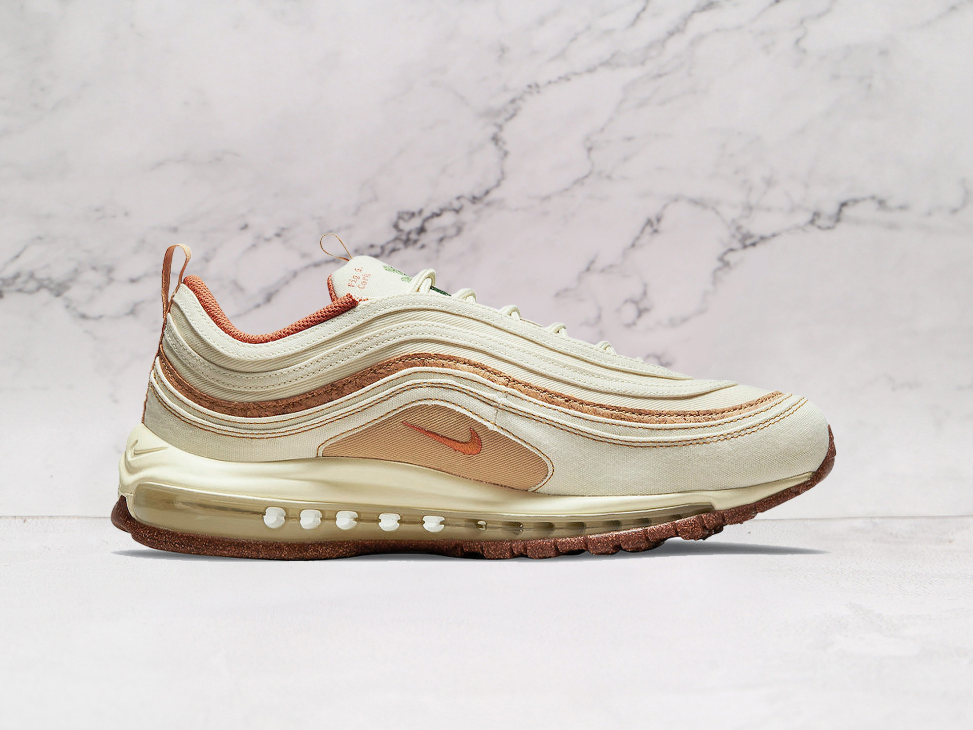 Air Max 97 Coconut Milk Cork medial angle showcasing its lightweight mesh build, speckled midsole, and full-length Air cushioning for day-long comfort