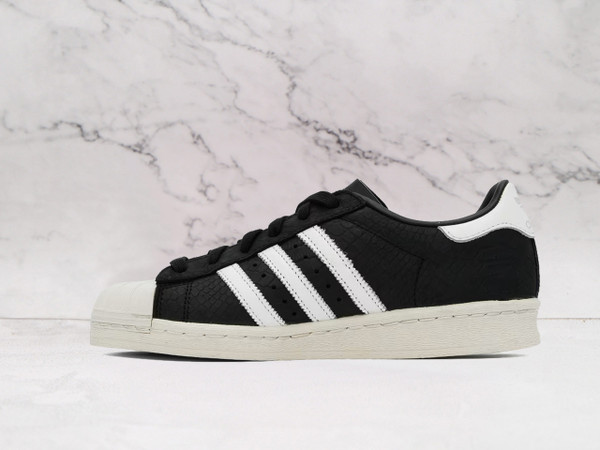 Adidas Superstar 82 Core Black Alumina Cream medial view with cream accents